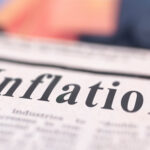 Inflation written newspaper close up shot to the text.